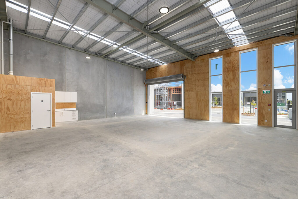 Inside the large brand new commercial building with roller door open. The Cube on Queen, Richmond.